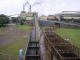 This shot shows the cane being transported into the factory by conveyer after being tipped